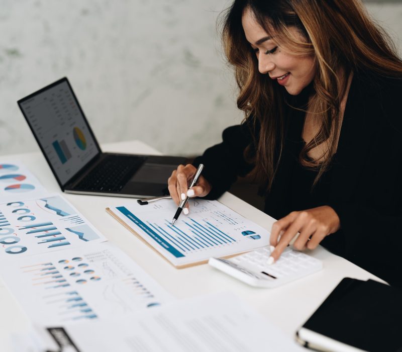 usiness-analyzing-investment-charts-with-calculator-laptop-accounting-and-technology-in-office.jpg